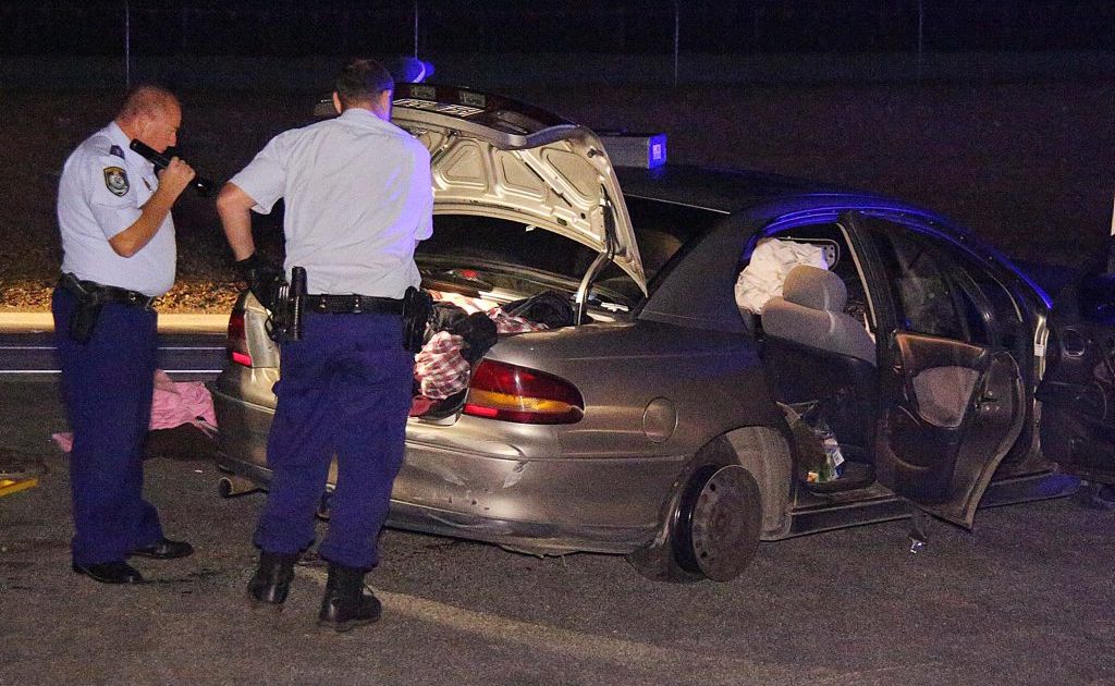 Police officers begin their search of the suspect vehicle that later turns up items of interest. Police officers begin their search of the suspect vehicle that later turns up items of interest.